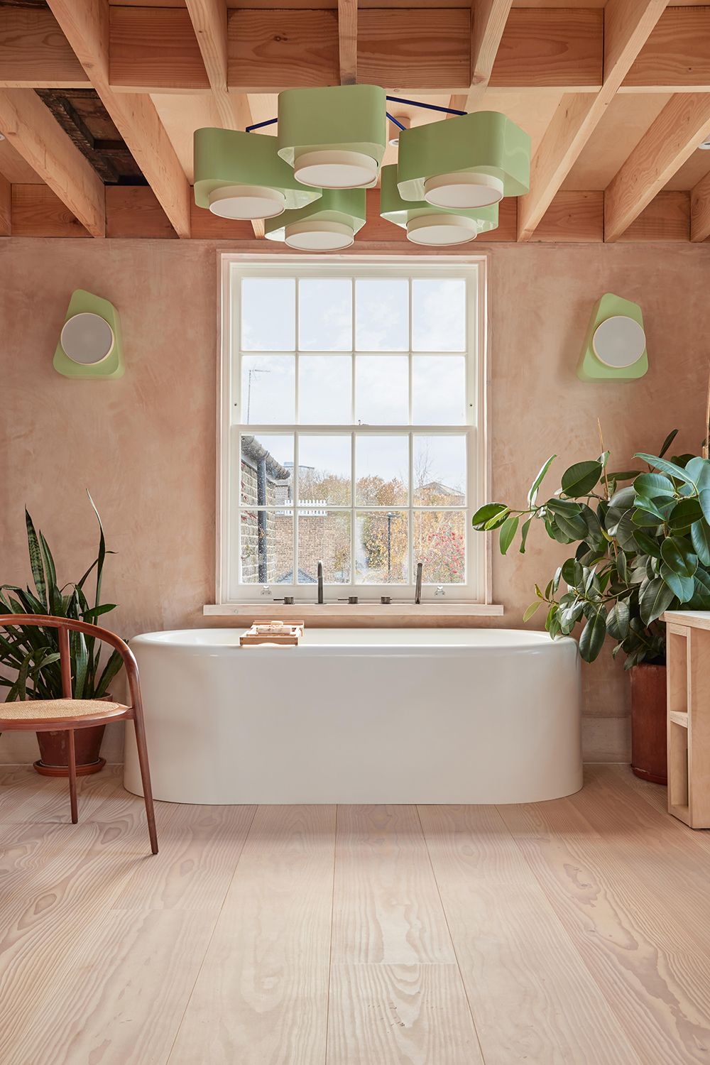 Bathroom with plaster pink walls and mint green chandelier