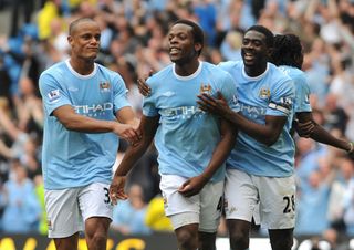 Manchester City's Nedum Onuoha (centre) celebrates scoring his sides second goal with teammates Kolo Toure (right) and Vincent Kompany (left)