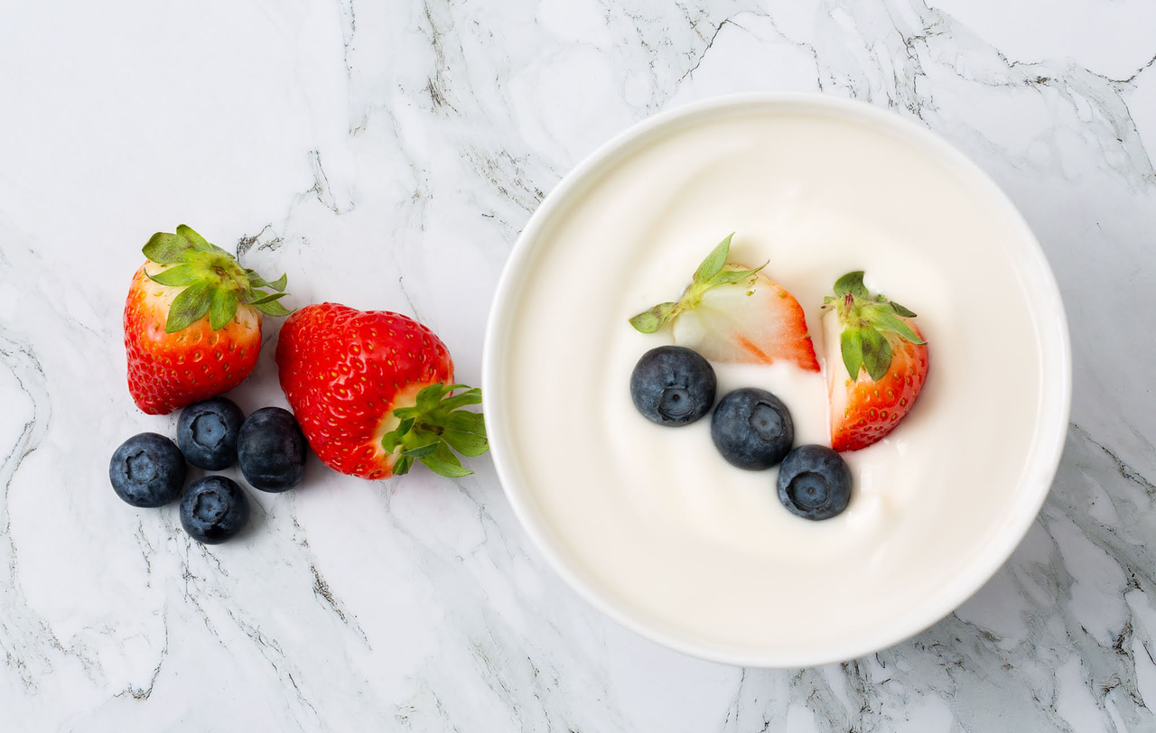 Yogurt with blueberries and strawberries in a bowl