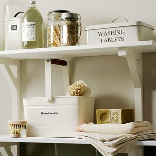 utility room with open shelves items organised in tins