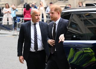 Prince Harry walking into High Court and getting out of his car