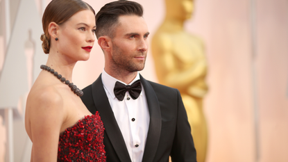 Recording artist Adam Levine (R) and Behati Prinsloo attend the 87th Annual Academy Awards at Hollywood &amp; Highland Center on February 22, 2015 in Hollywood, California. 