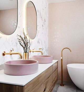 An example of bathroom tile ideas showing a wall of mini pink hexagon tiles next to a marble wall of metro tiles