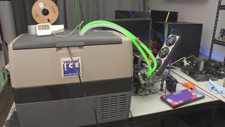 A photograph of a graphics card being chilled by a portable camping freezer.