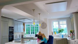 An infrared heating system on the ceiling of a kitchen