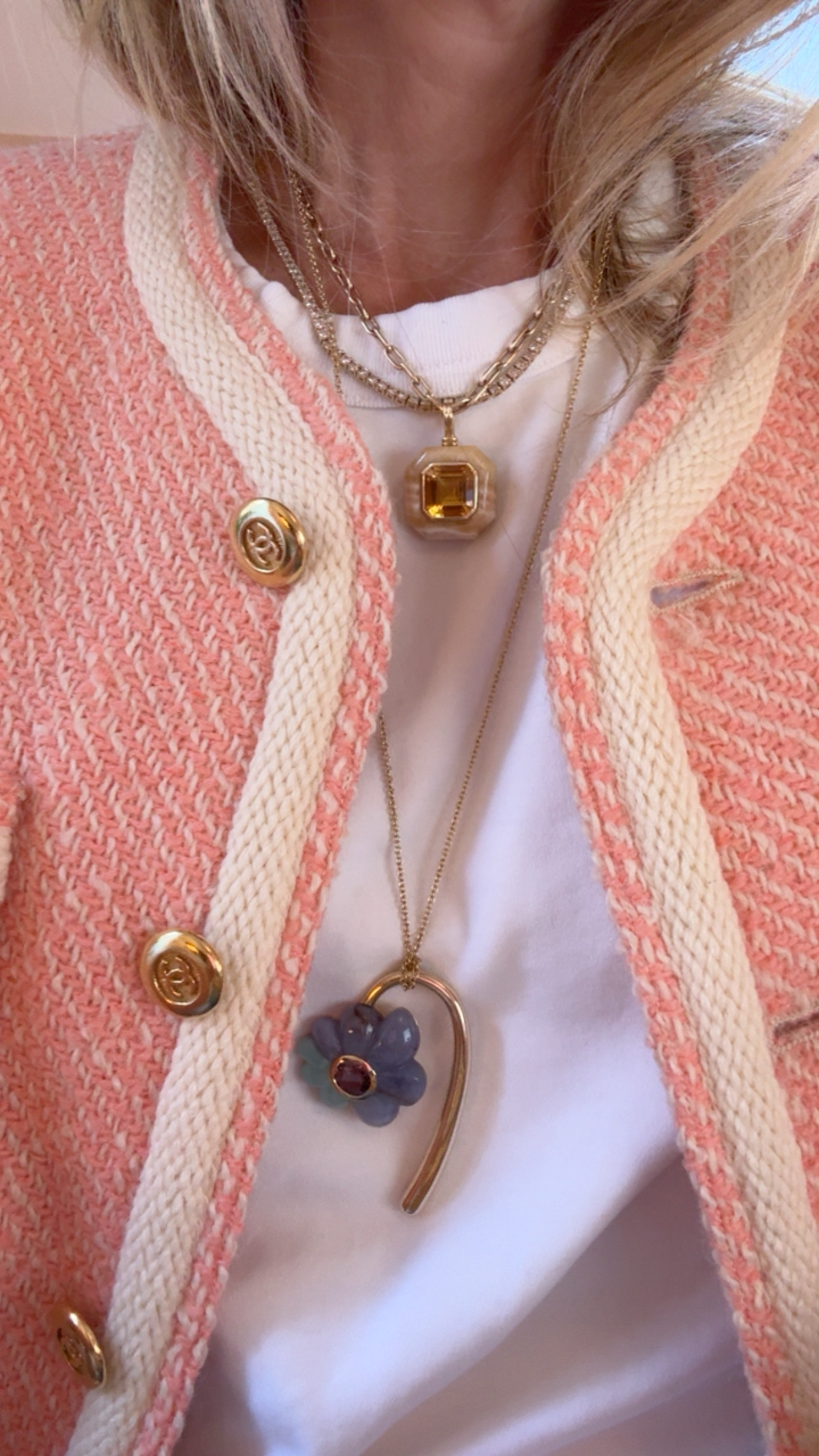 Marina Larroudé wearing bright peach jacket with floral necklaces