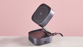 The 2-in-1 UGreen charger is folded out into a stand, the Qi earbud charging area can be seen on the surface of the base module, and the USB-C output is visible on the side.