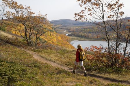 Woman hikes in the mountains in Michigan.