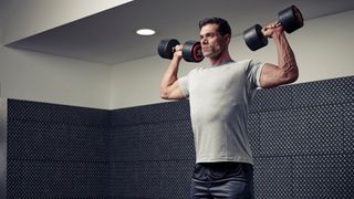 Man demonstrates starting position of the dumbbell shoulder press