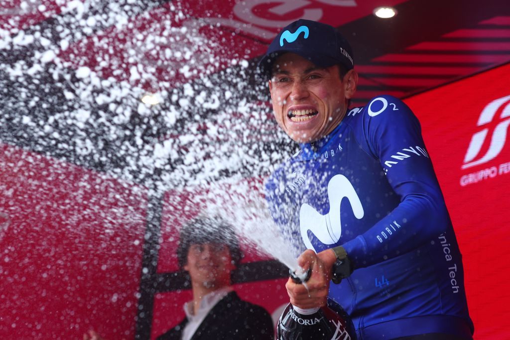 Movistar Teams Colombian rider Einer Rubio sprays sparkling wine as he celebrates on the podium after winning the thirteenth stage of the Giro dItalia 2023 cycling race which start was transfered from Borgofranco dIvrea to Le Chable in Switzerland due to bad weather conditions and CransMontana on May 19 2023 Photo by Luca Bettini AFP Photo by LUCA BETTINIAFP via Getty Images
