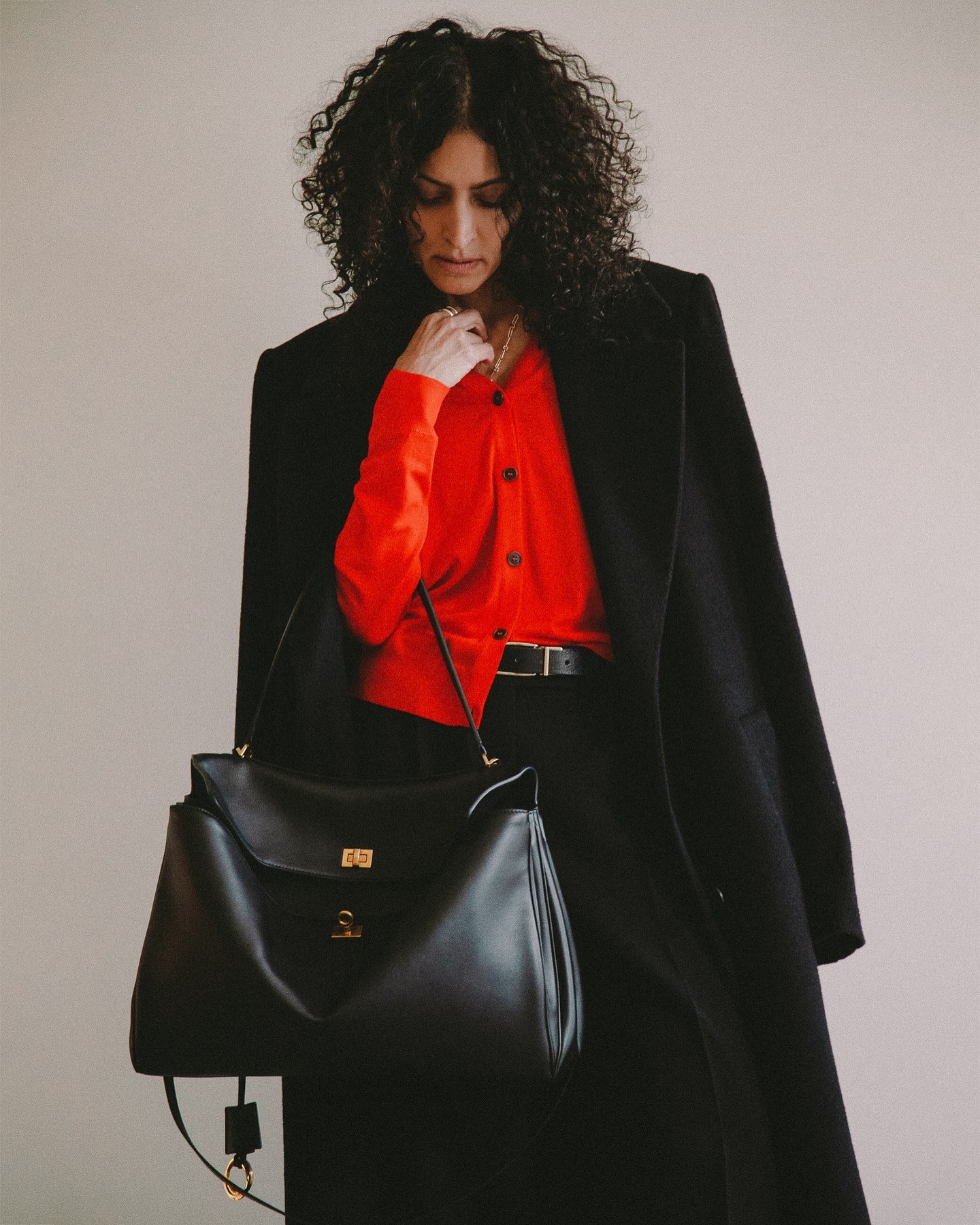 Neelam Gill wears a Balenciaga Rodeo bag.