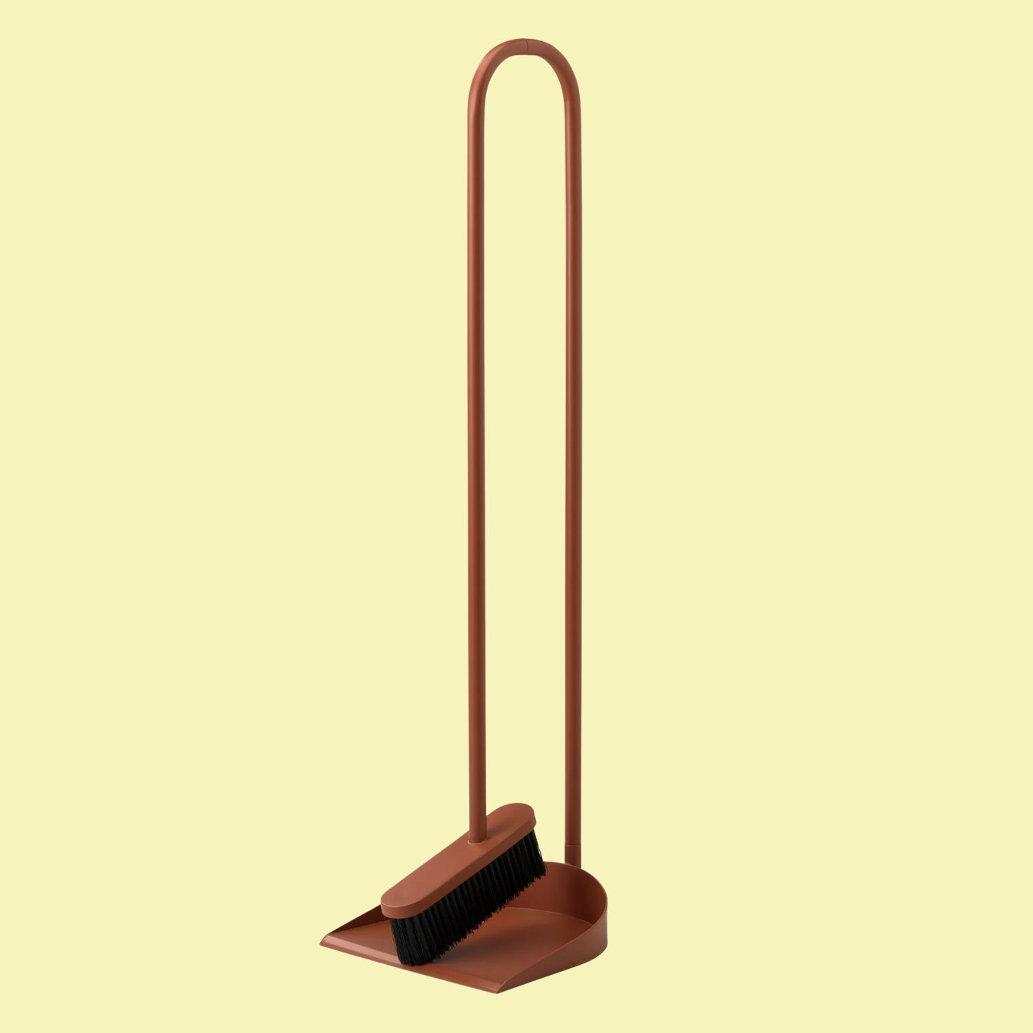 A rust-colored broom and pan