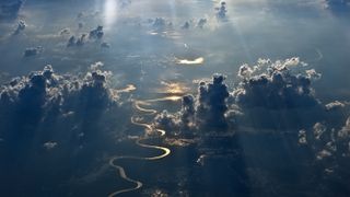 In this aerial view the Musi River glistens gold in South Sumatra, Indonesia.