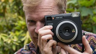 Fujifilm Instax SQ40 camera in reviewer's hands