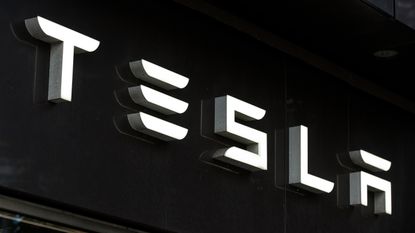 White Tesla logo on black background