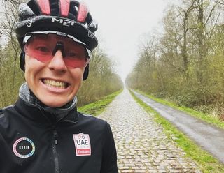 Tadej Pogacar snaps a photo for social media from recon ride on cobbles to be included in 2022 Paris-Roubaix and Tour de France