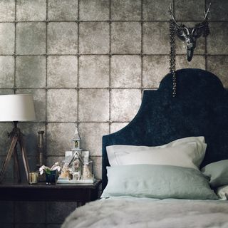 bedroom with fabric tiles and metallic headboard