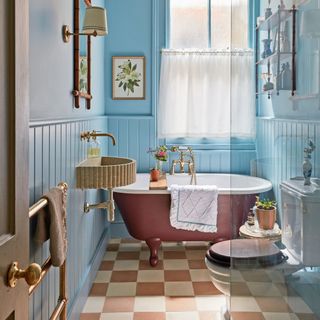 Blue painted bathroom with pink painted bath tub