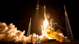 A SpaceX Falcon 9 rocket launching at night from a Florida pad 