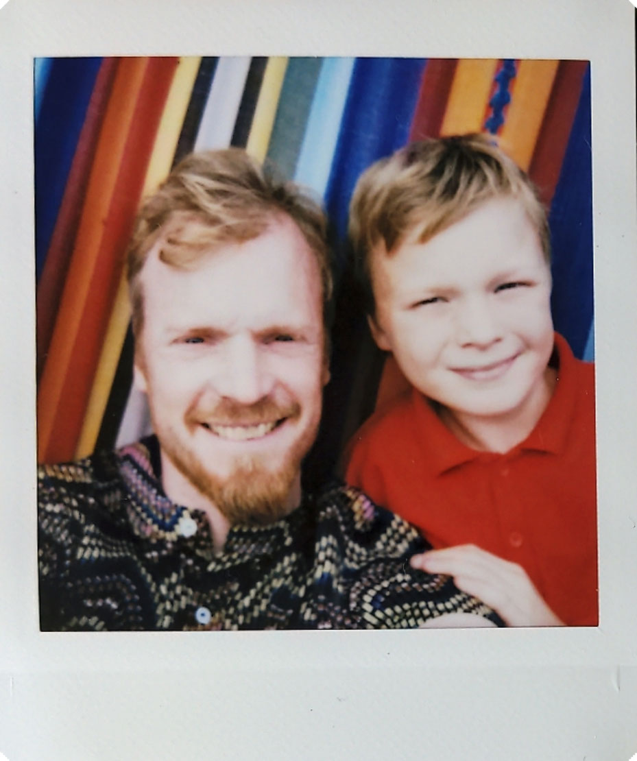 Digitized instant photo taken with the Fujifilm Instax SQ40 of selfie with two people on colorful backdrop