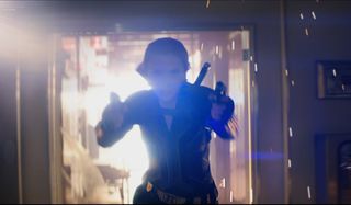 Scarlett Johansson runs from an explosion with her guns drawn in Black Widow.