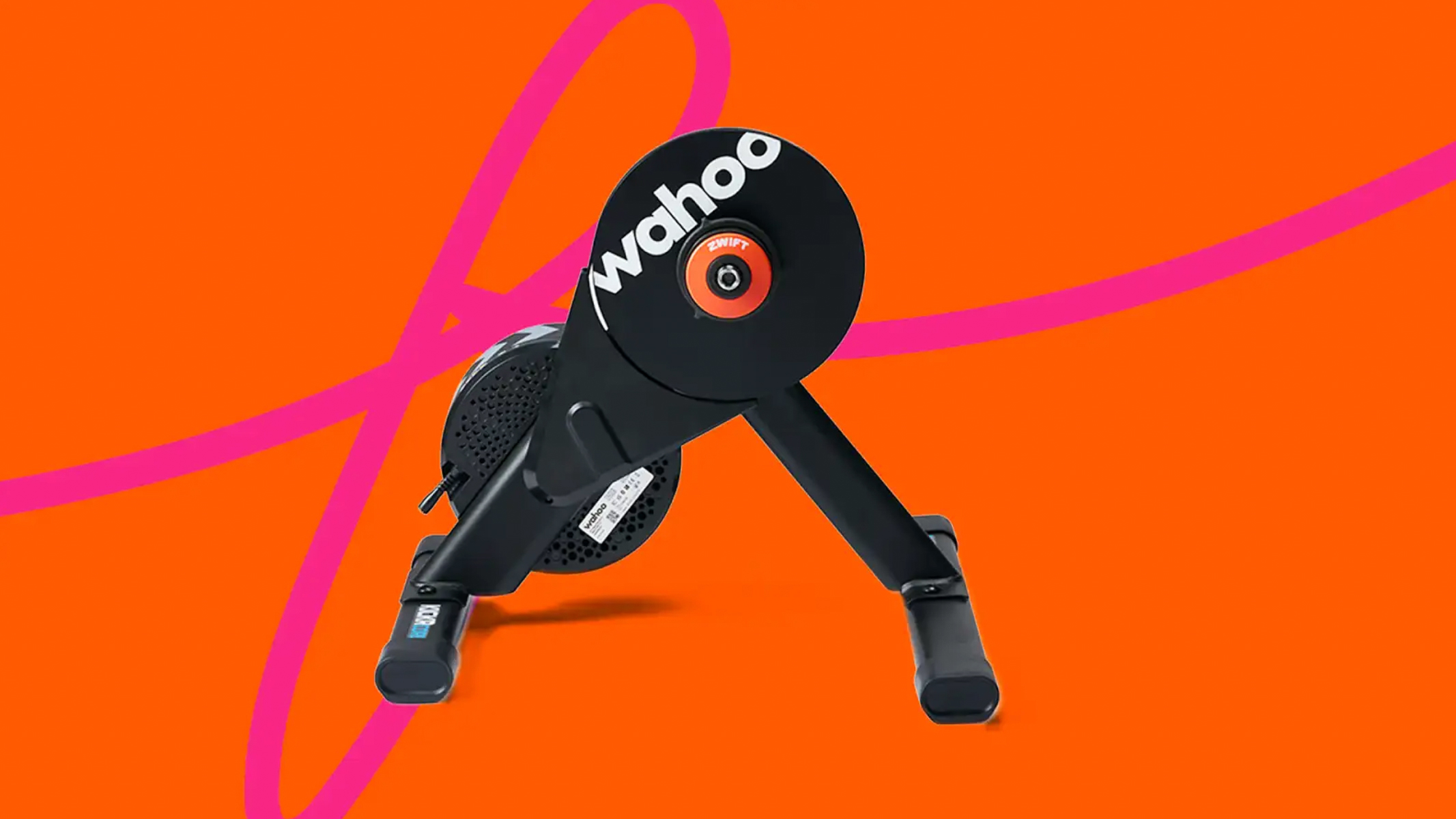 The Wahoo Kickr Core 2 with Zwift Cog and Click on an orange and pink backdrop
