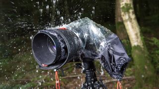 Manfrotto E-702 PL Elements rain cover covering a camera in the rain