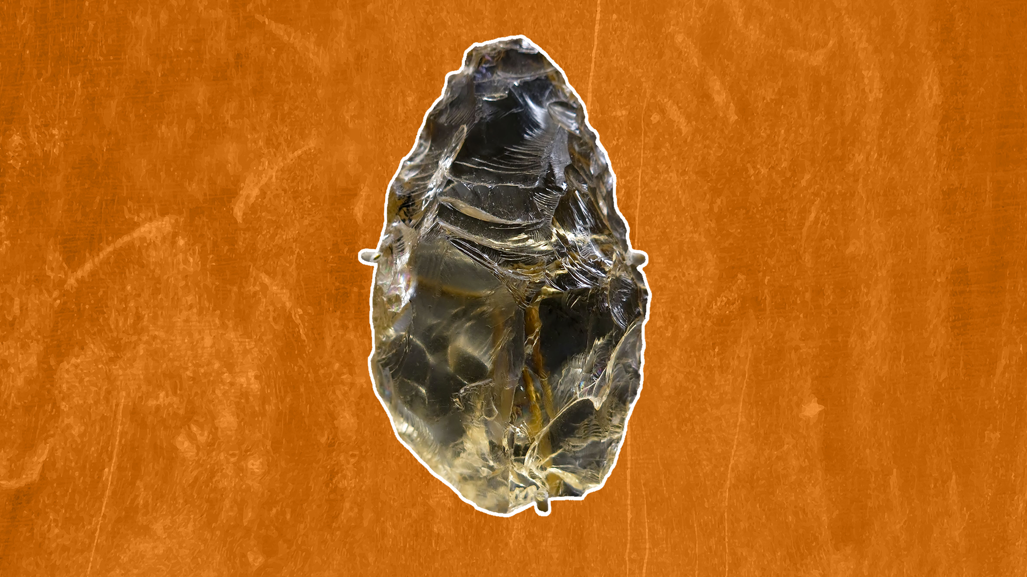 a crystal scraper tool on an orange background