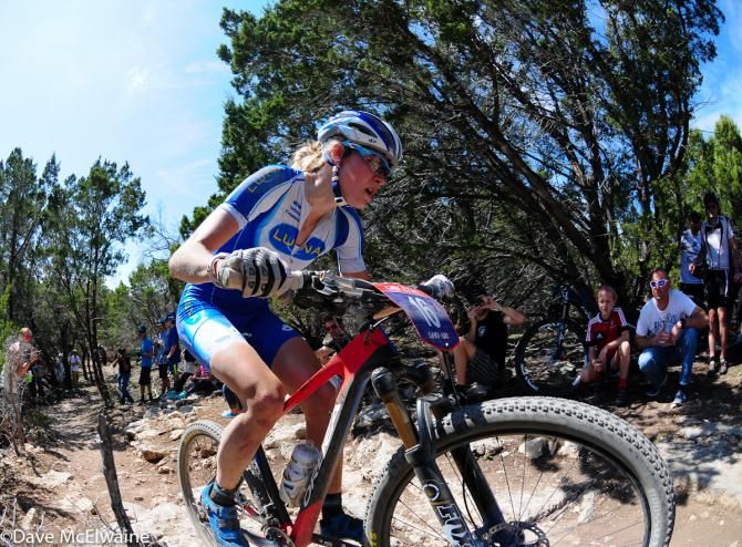 Maghalie Rochette (Luna Pro Team) riding technical rocks in fifth position