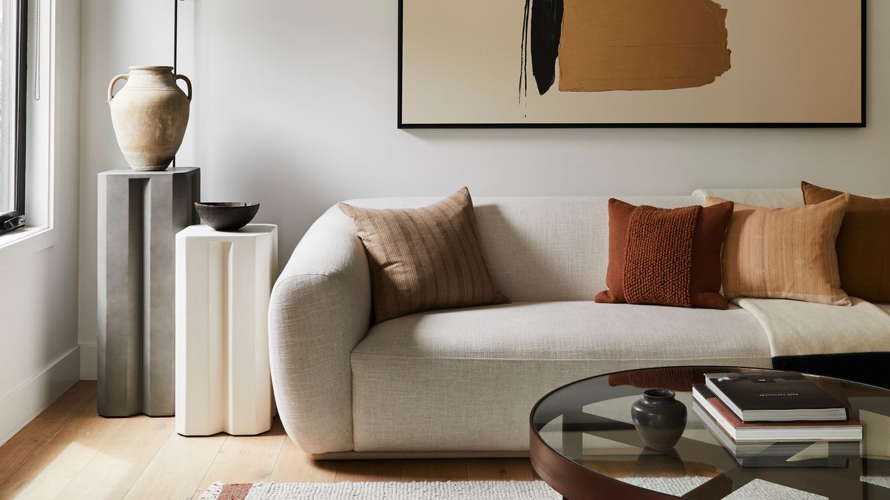 a living room with white walls and a white sofa
