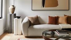 a living room with white walls and a white sofa