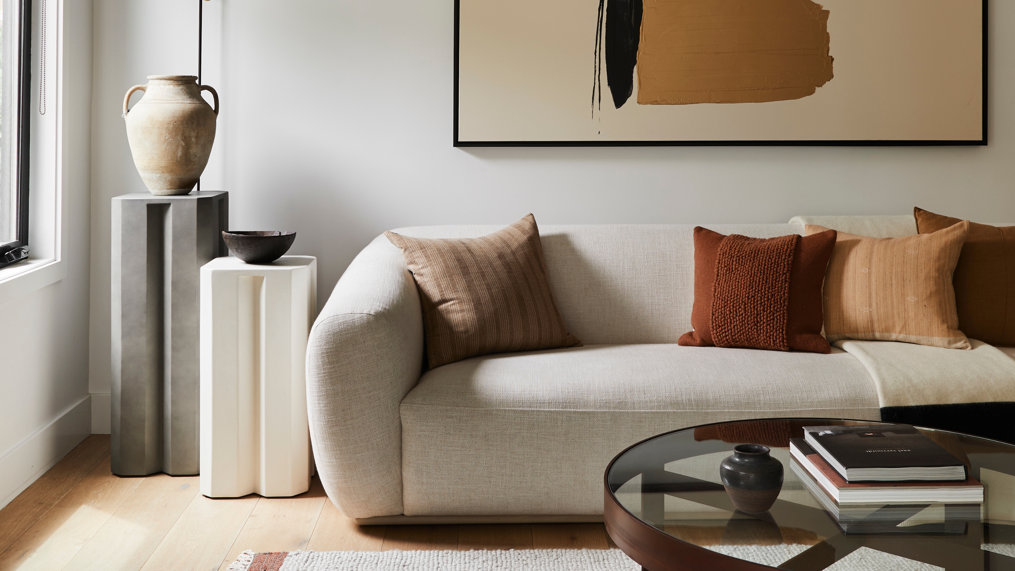a living room with white walls and a white sofa
