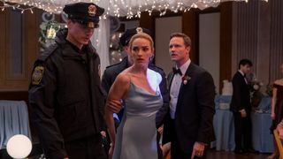 Brianne Howey as Georgia being arrested while Scott Porter as Mayor Paul Randolph watches in Ginny & Georgia season 2