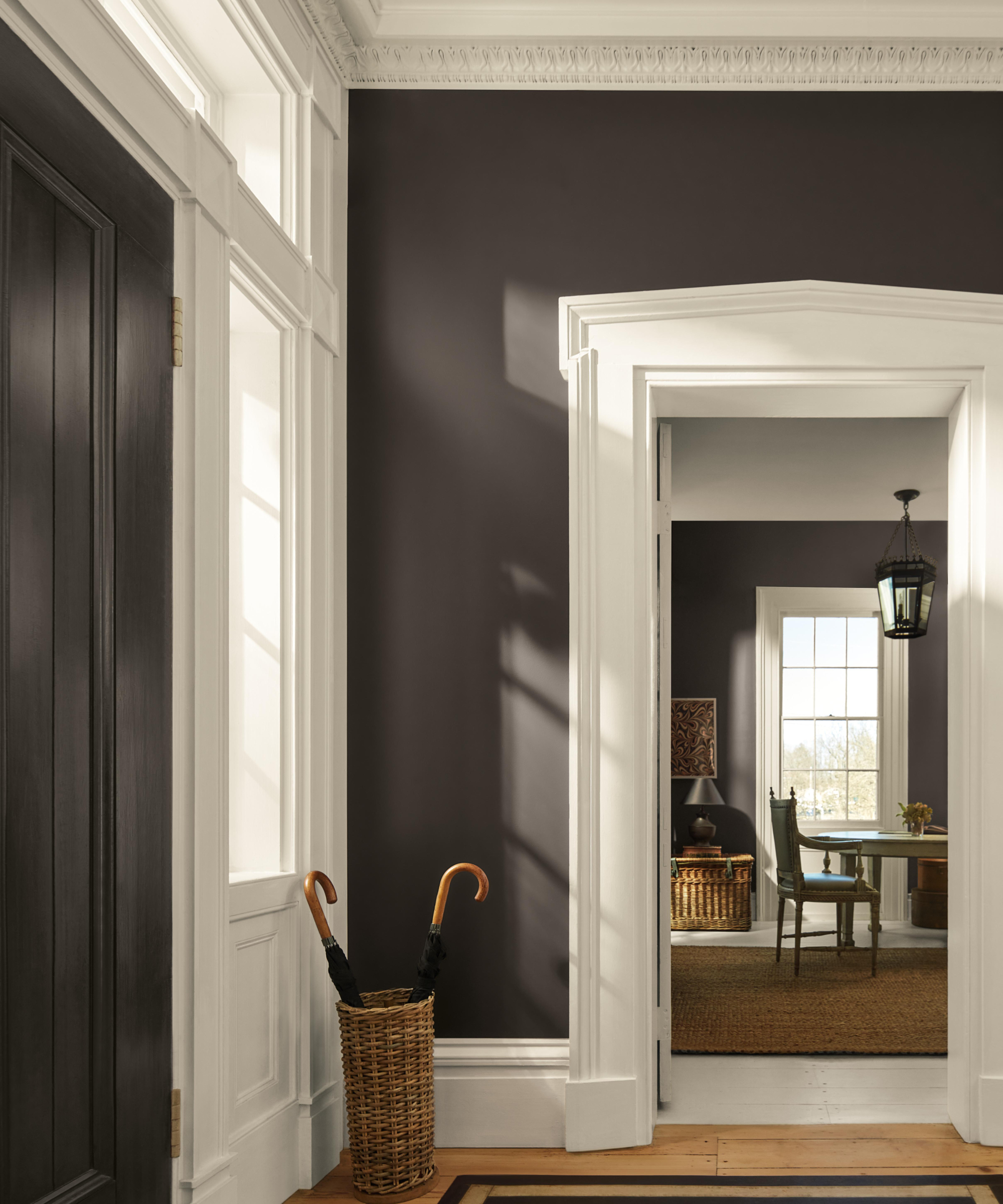 entrance hallway painted in dark grey/brown with white woodwork