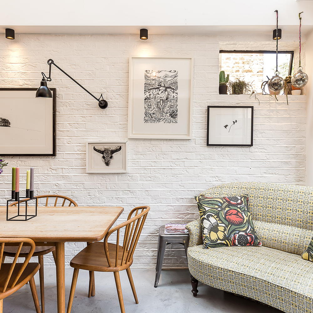 white dining room with dining table and sofa