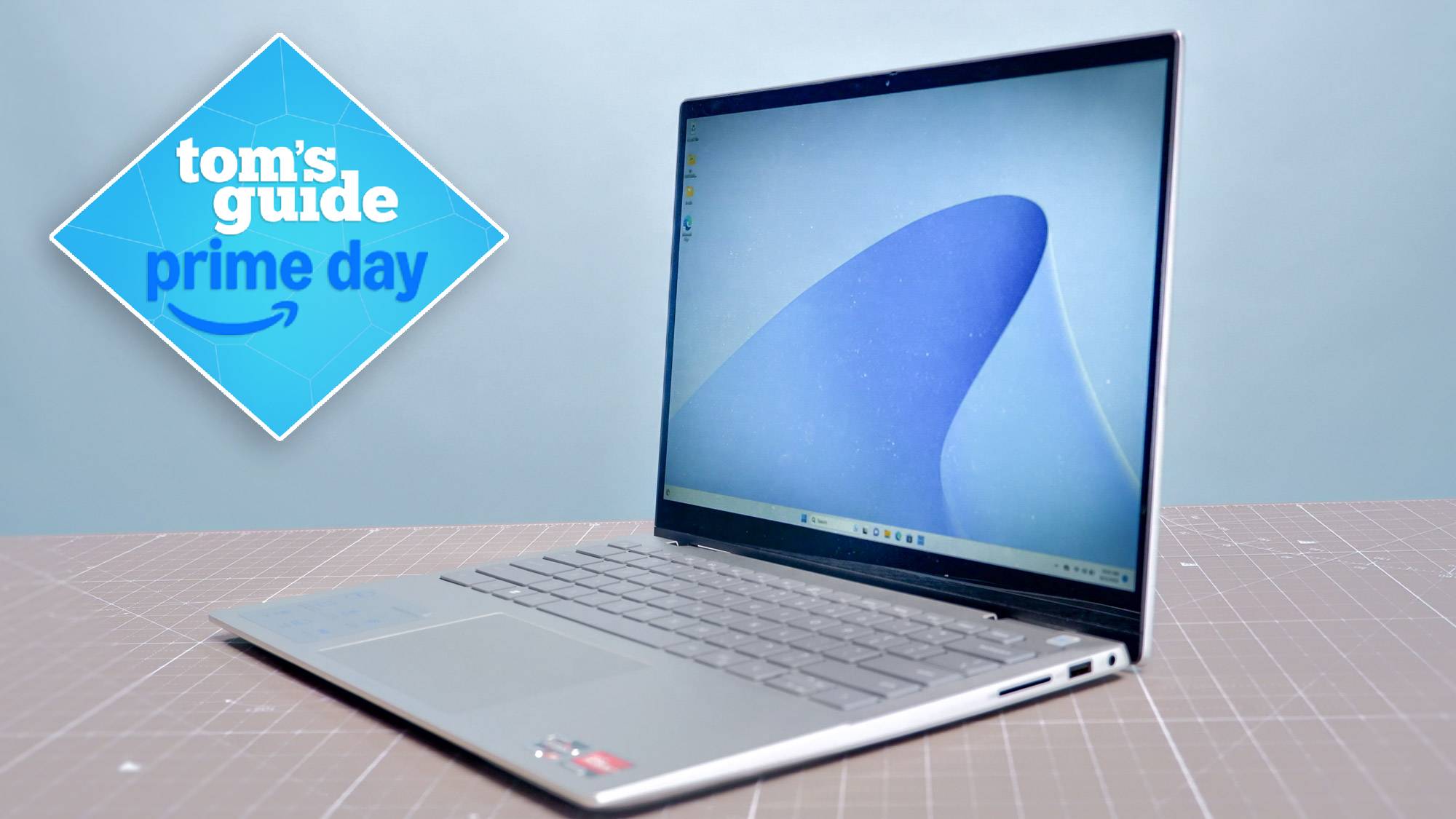 Dell 14 Plus on table with Tom's Guide Prime Day badge