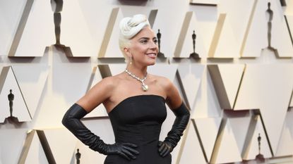 Lady Gaga on the red carpet of the Academy Awards in a black gown and diamonds