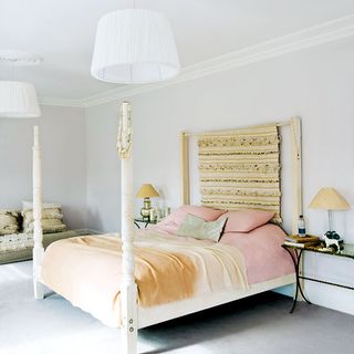 bedroom with pillows white wall and lamp