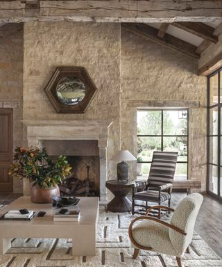 family room with fireplace steel framed windows and square white coffee table with wooden beams