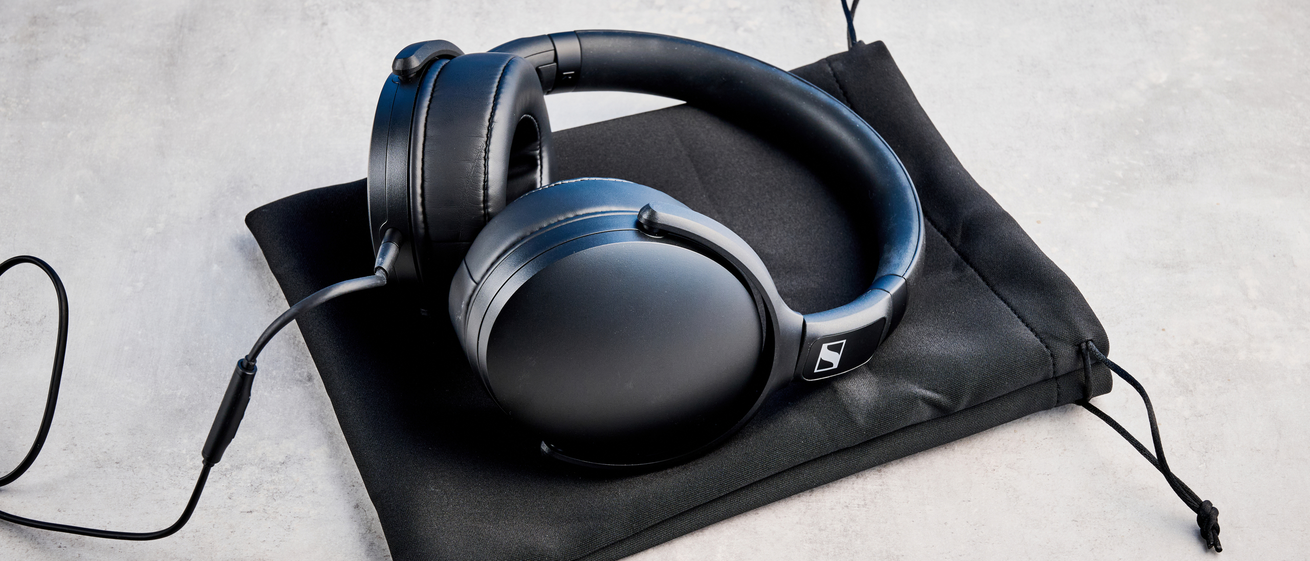 Sennheiser HD 400U on top of their pouch, on a stone surface
