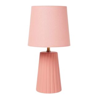 A pink scalloped edge table lamp