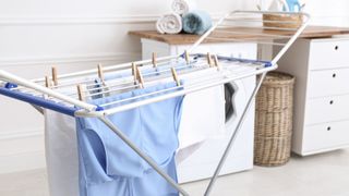 clothes drying on airer in laundry room