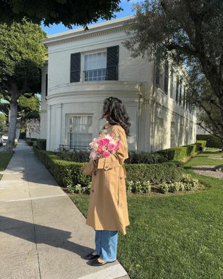 @kristincabat wears a camel trench coat