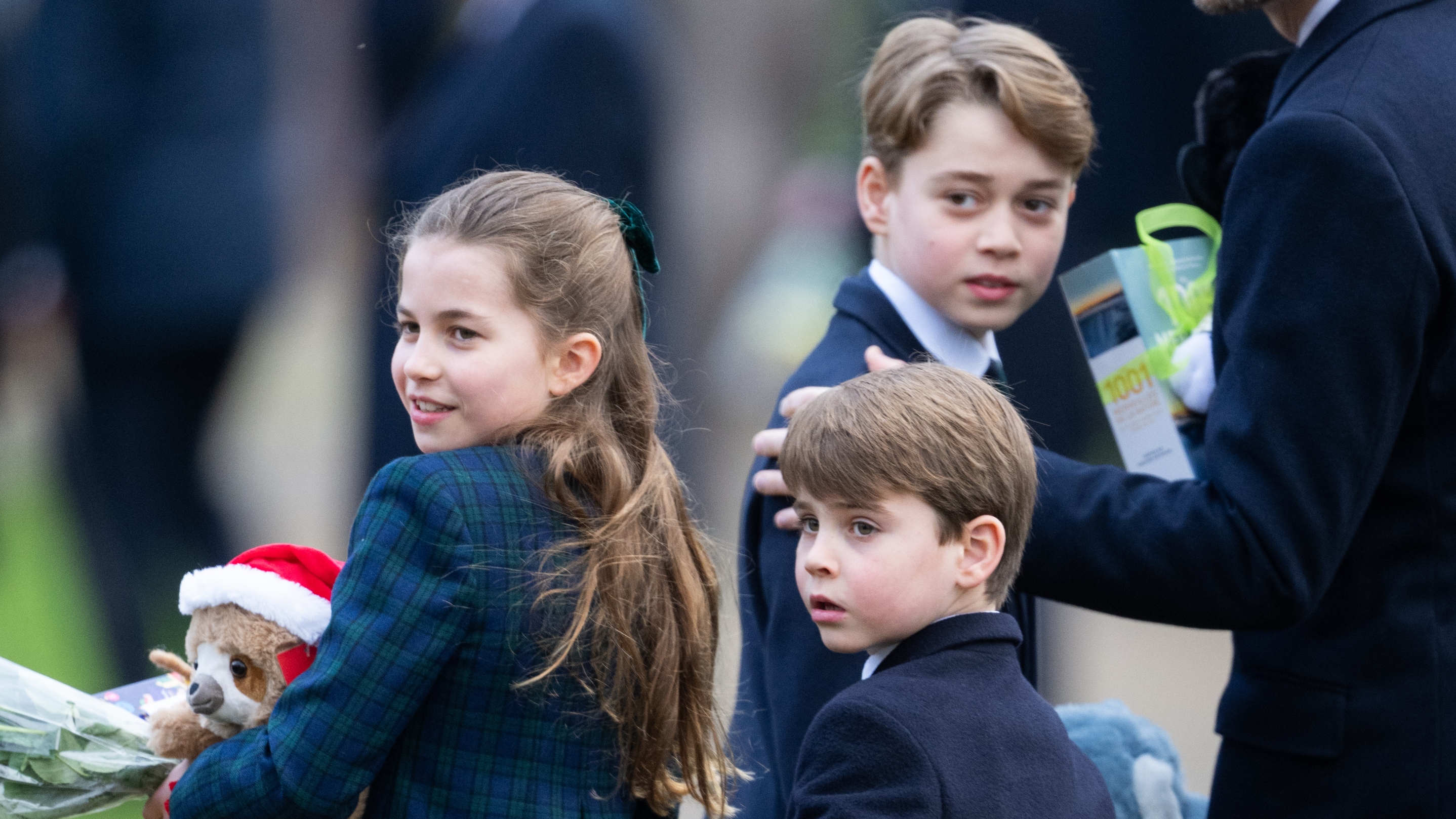 Princess Charlotte, Prince Louis and Prince George of Wales look round after attending the Christmas Morning Service on December 25, 2024
