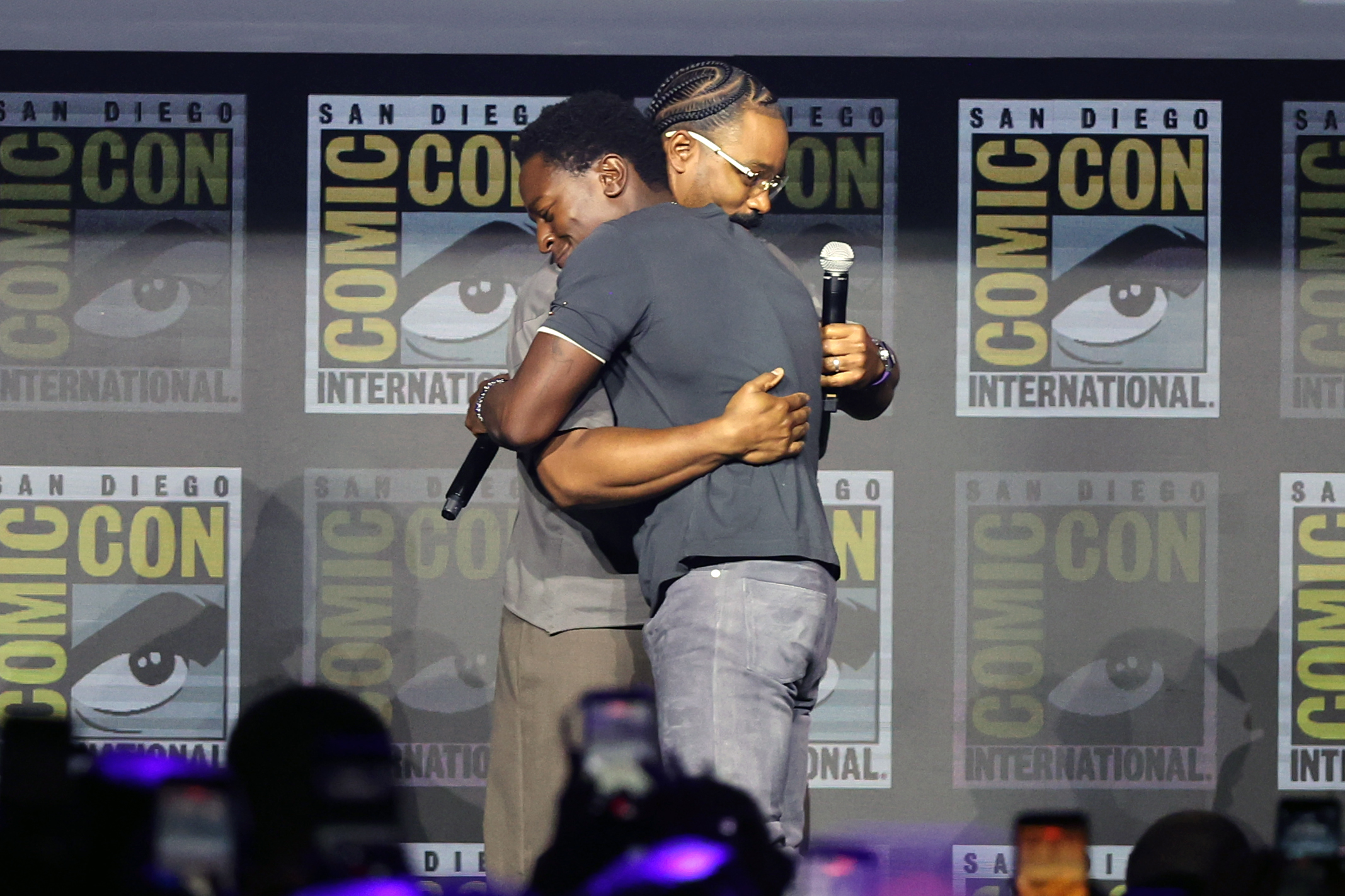 From L-R David Jonsson and Ryan Coogler are seen onstage during the Marvel Studios Panel at 2026 San Diego Comic-Con, mid-hug