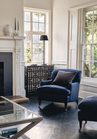 apartment ideas living room with dark wooden floor, navy velvet armchairs, console table, fireplace