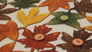 A collection of Leaf tokens and tiles on a white surface