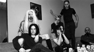 Scott Putesky (standing) with Marilyn Manson, Trent Reznor, Twiggy Ramirez, Madonna Wayne Gacy and Ginger Fish in 1995