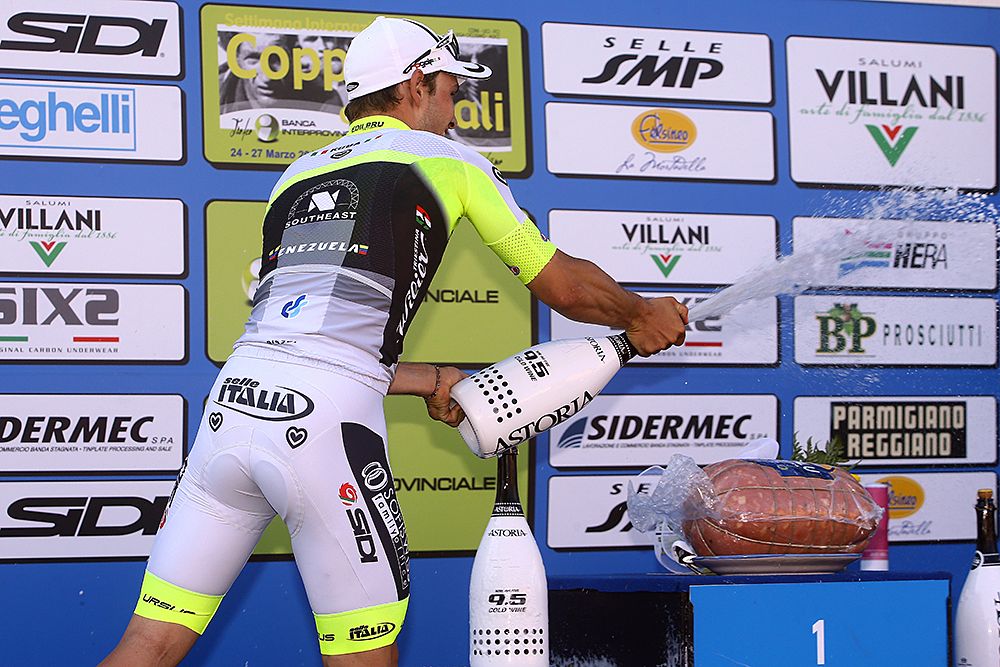 Jakub Mareczko (Southeast) sprays his rivals on the podium after winning the bunch sprint