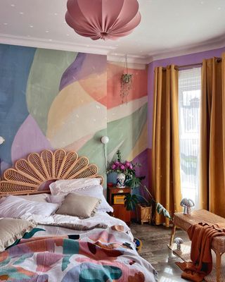 A colorful bedroom with a bed, table, and yellow blackout curtains